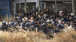 Riot police officers cordon off the area after migrants arrive on Spanish soil and crossing the fences separating the Spanish enclave of Melilla from Morocco in Melilla, Spain, Friday, June 24, 2022. Dozens of migrants stormed the border crossing between Morocco and the Spanish enclave city of Melilla on Friday in what is the first such incursion since Spain and Morocco mended diplomatic relations last month. (AP Photo/Javier Bernardo)