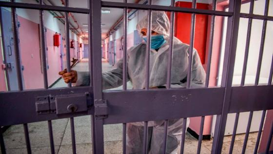 A prison warden, wearing personal protective equipment due to the COVID-19 pandemic, locks a gate at the Oukacha prison in Casablanca on May 18, 2020. (Photo by FADEL SENNA / AFP) (Photo by FADEL SENNA/AFP via Getty Images)
